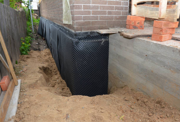 Happy homeowners after waterproofing job in Grand River